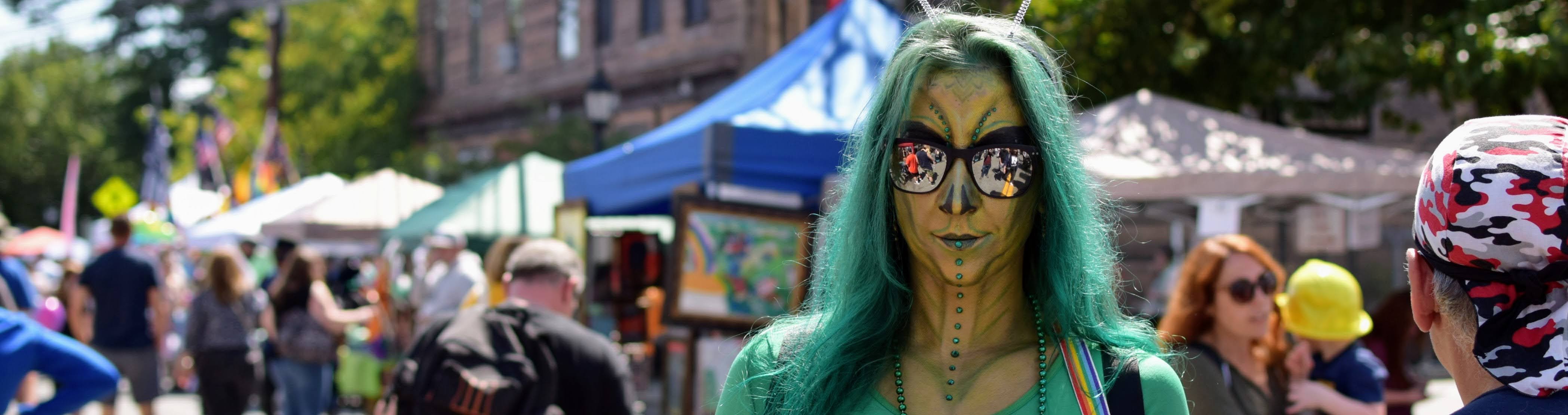 A woman in green alien makeup