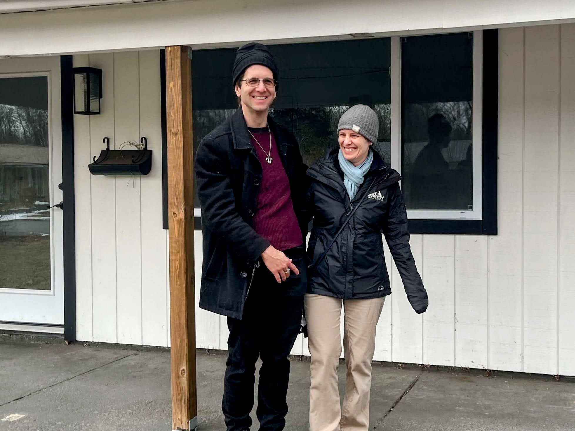Amber and me hugging in front of our new house